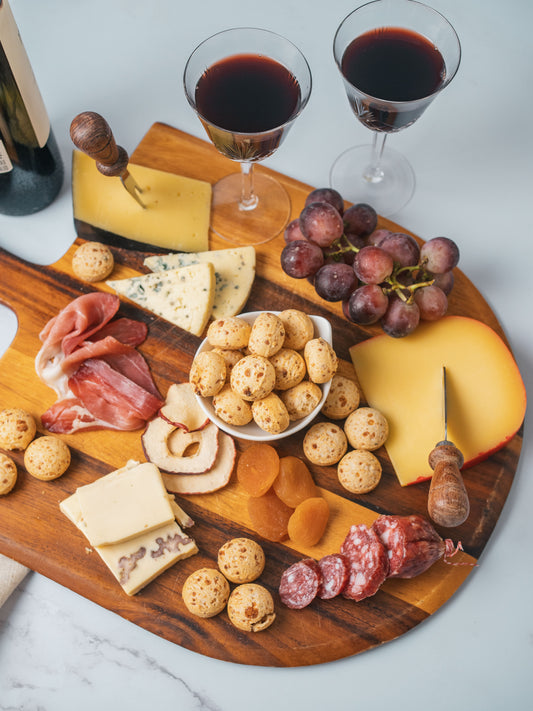 Charcuterie board with cheese and wine